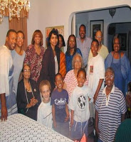Varnette Honeywood wears an apron, at home with her mother (Center seated) and family on August 30, 2003.