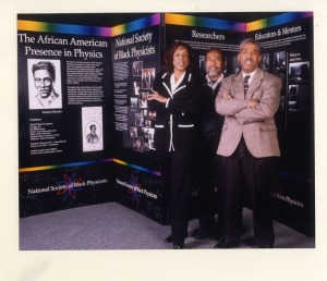 Dr. Cynthia McIntyre, Mickens, and Dr. James Stith in front of "African American Presence in Physics" exhibit, 1999. Mickens spearheaded this traveling exhibit with the National Society of Black Physicists as part of the American Physical Society's Centennial celebration.